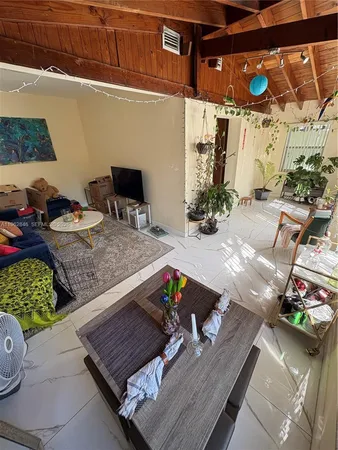 a view of a balcony with chairs and potted plants