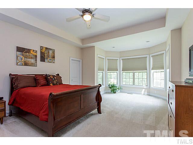 13028 Saxon Way Raleigh, NC 27613 - Photo 12 of 21 a spacious bedroom with a bed and a large window