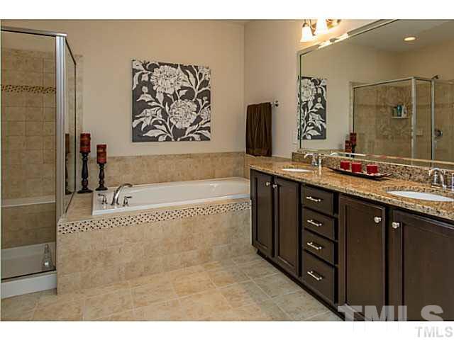13028 Saxon Way Raleigh, NC 27613 - Photo 13 of 21 a bathroom with a tub sink and mirror