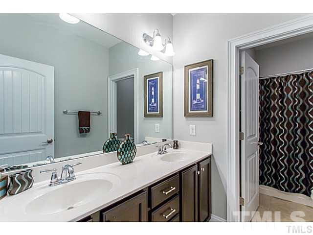 13028 Saxon Way Raleigh, NC 27613 - Photo 14 of 21 a bathroom with a double vanity sink and a mirror