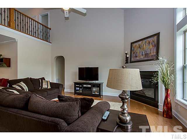 13028 Saxon Way Raleigh, NC 27613 - Photo 21 of 21 a living room with furniture and a fireplace