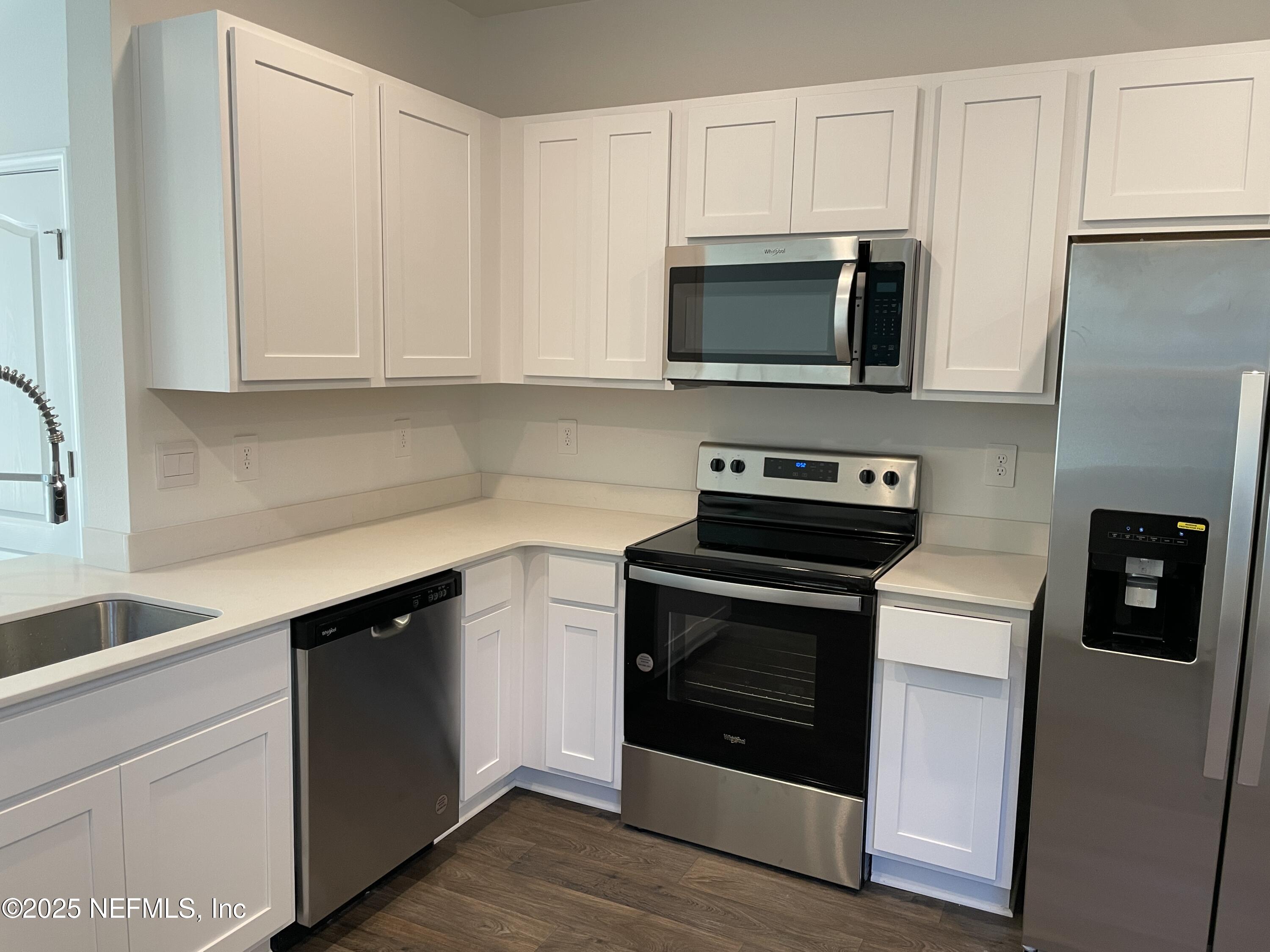 a kitchen with stainless steel appliances granite countertop a stove microwave and sink