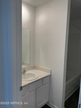 a white toilet sitting next to a bath tub