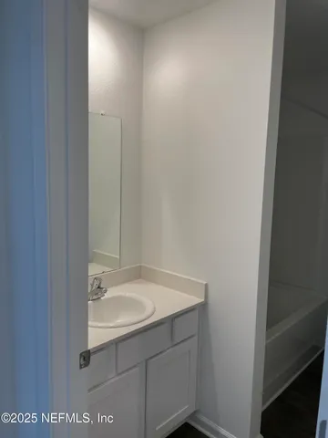 a white toilet sitting next to a bath tub