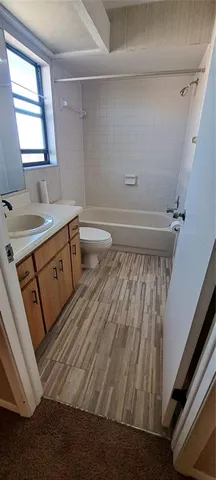 a bathroom with a sink toilet and window