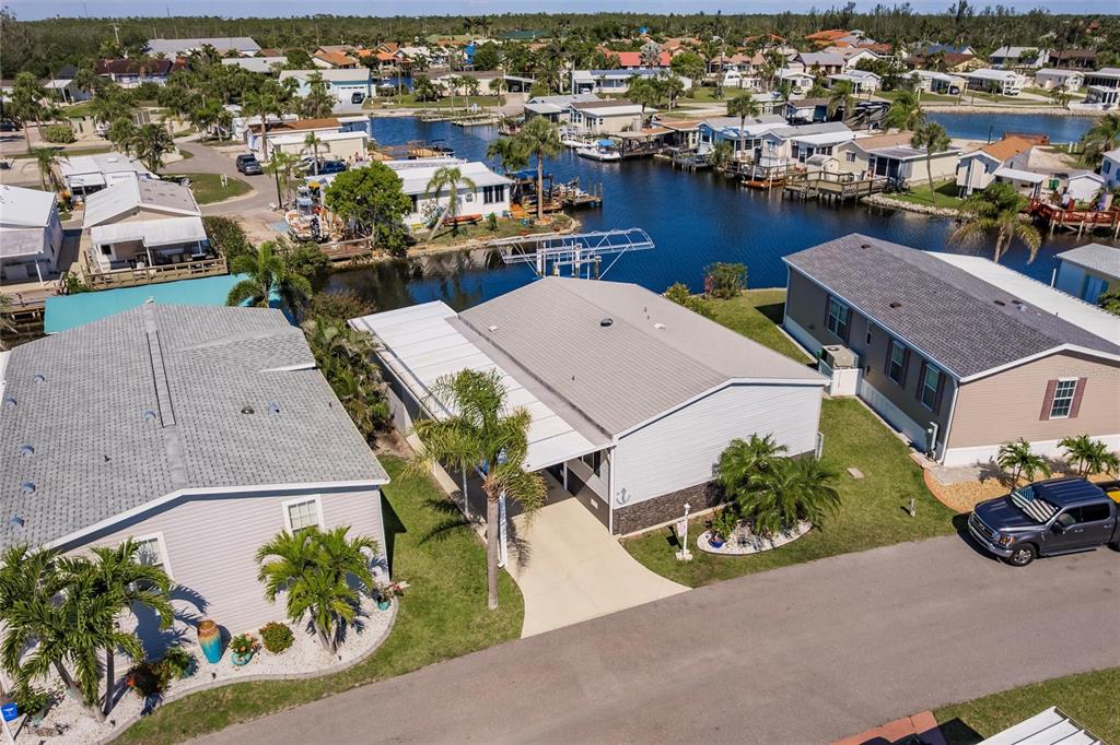 an aerial view of a house with swimming pool and outdoor seating