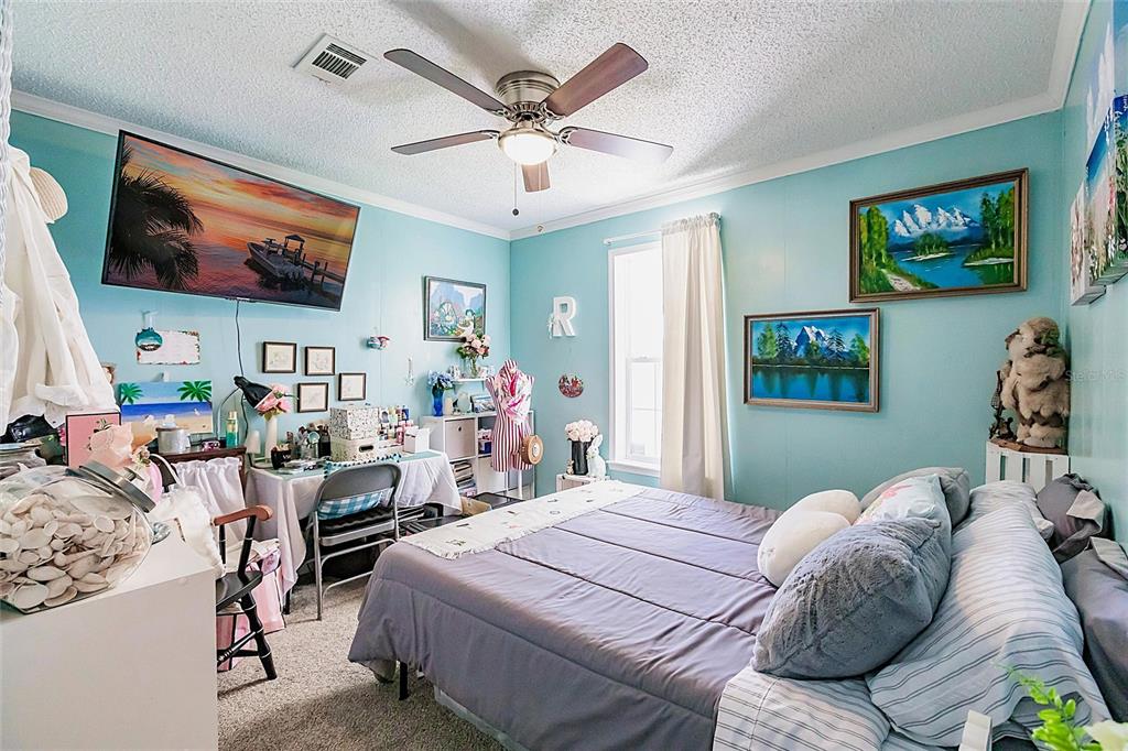21 Rotterdam Punta Gorda, FL 33950 - Photo 13 of 40 a bedroom with a bed furniture and a flat screen tv