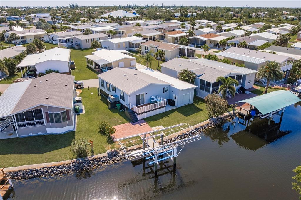 21 Rotterdam Punta Gorda, FL 33950 - Photo 26 of 40 an aerial view of a house with a garden and lake view