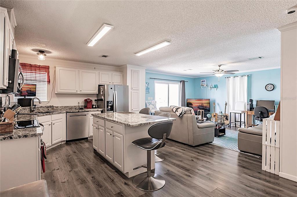 21 Rotterdam Punta Gorda, FL 33950 - Photo 4 of 40 a living room with kitchen island furniture and wooden floor