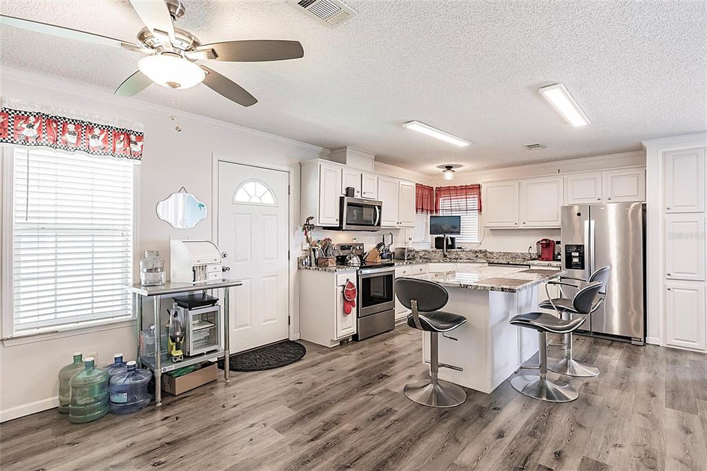 21 Rotterdam Punta Gorda, FL 33950 - Photo 5 of 40 a kitchen with a sink appliances and wooden floor