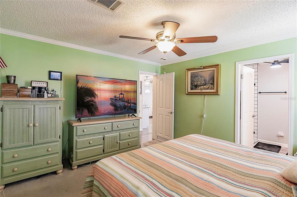 21 Rotterdam Punta Gorda, FL 33950 - Photo 10 of 40 a bedroom with a bed and a flat screen tv
