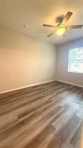 an empty room with stairs and windows