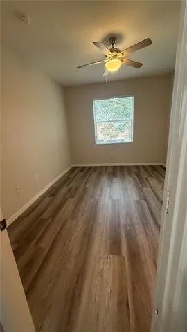 a bathroom with a granite countertop sink a toilet a mirror and shower