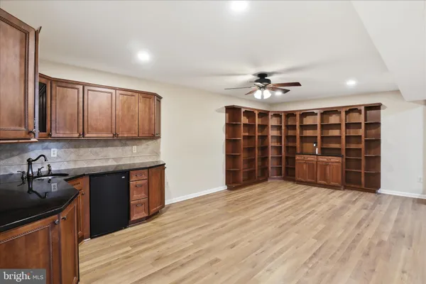 a view of an empty room with a kitchen and a sink