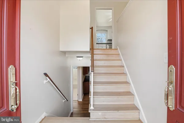 a view of staircase with white walls and windows