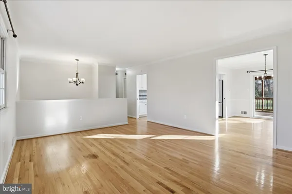 a view of a kitchen with wooden floor and a sink