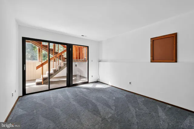 a view of balcony with refrigerator and wooden floor