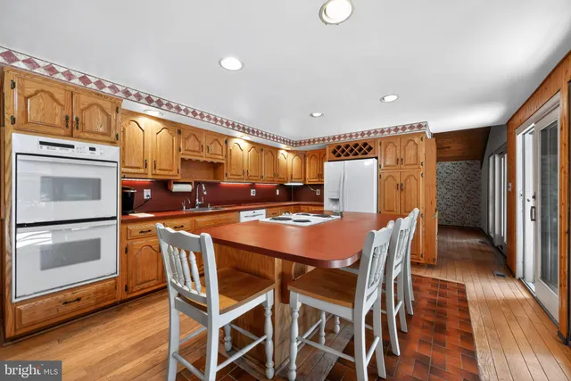 a kitchen with counter top space and wooden floor