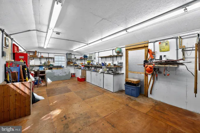 an aerial view of a house with a yard and large trees
