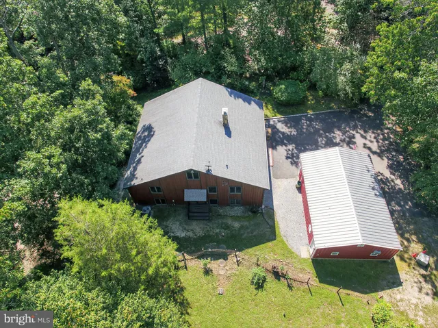 a view of a house with a large window and a yard