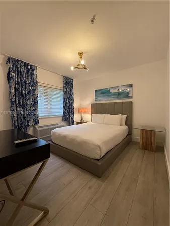 a bedroom with a bed lamp and a chandelier