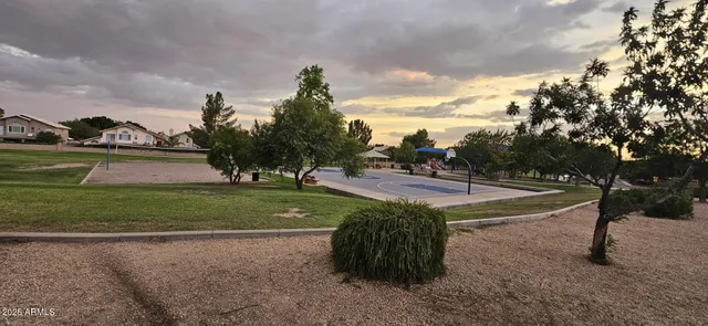 a view of a field with sitting area