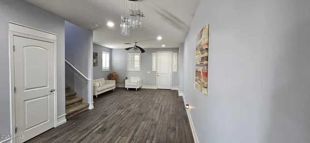 a view of a room with wooden floor and staircase