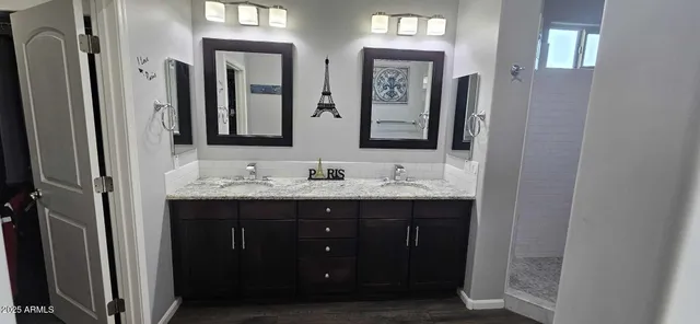 a bathroom with a double vanity sink and a mirror