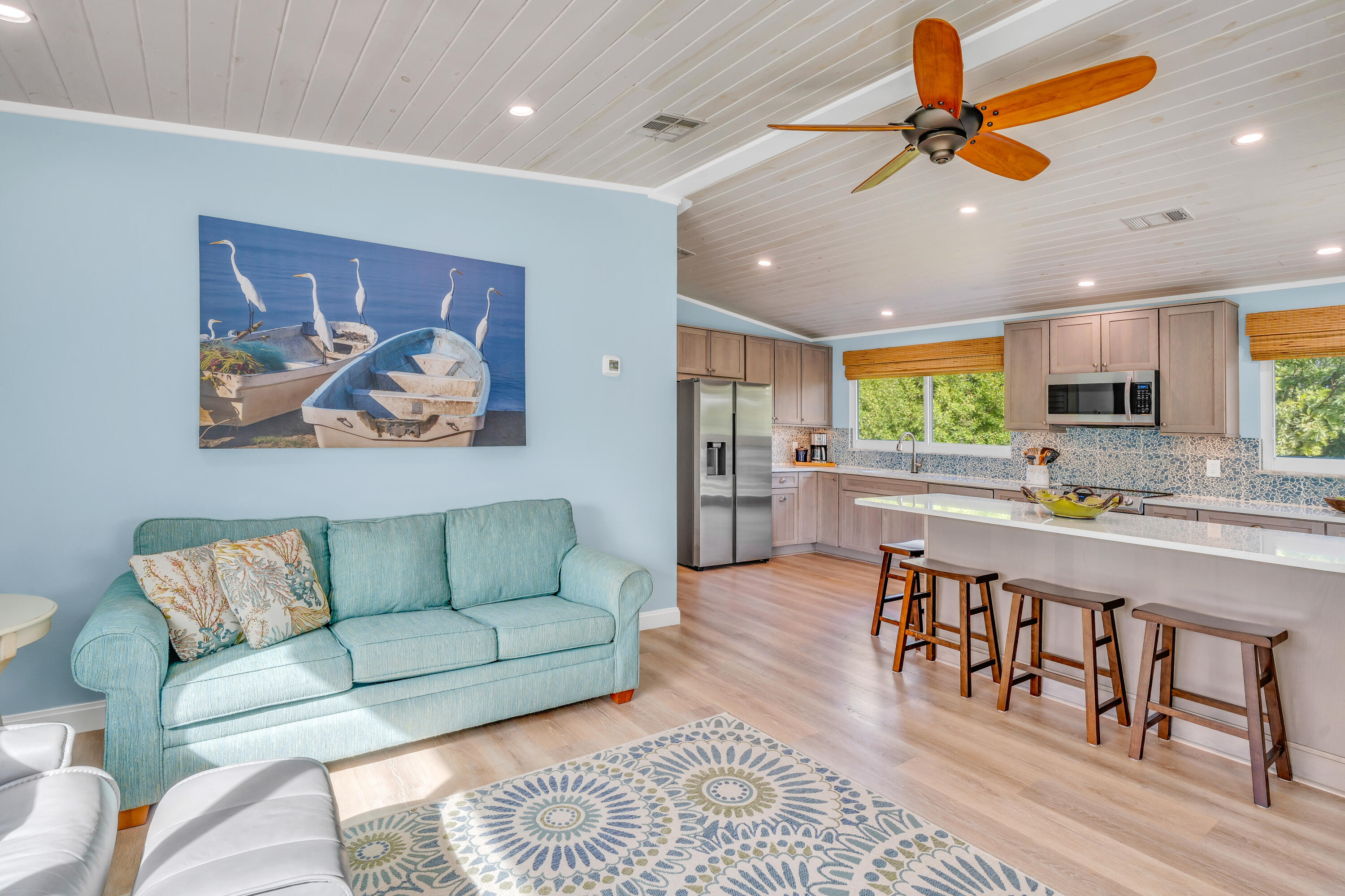 3987 Gordon Road Big Pine Key, FL 33043 - Photo 13 of 49 a living room with furniture kitchen view and a wooden floor