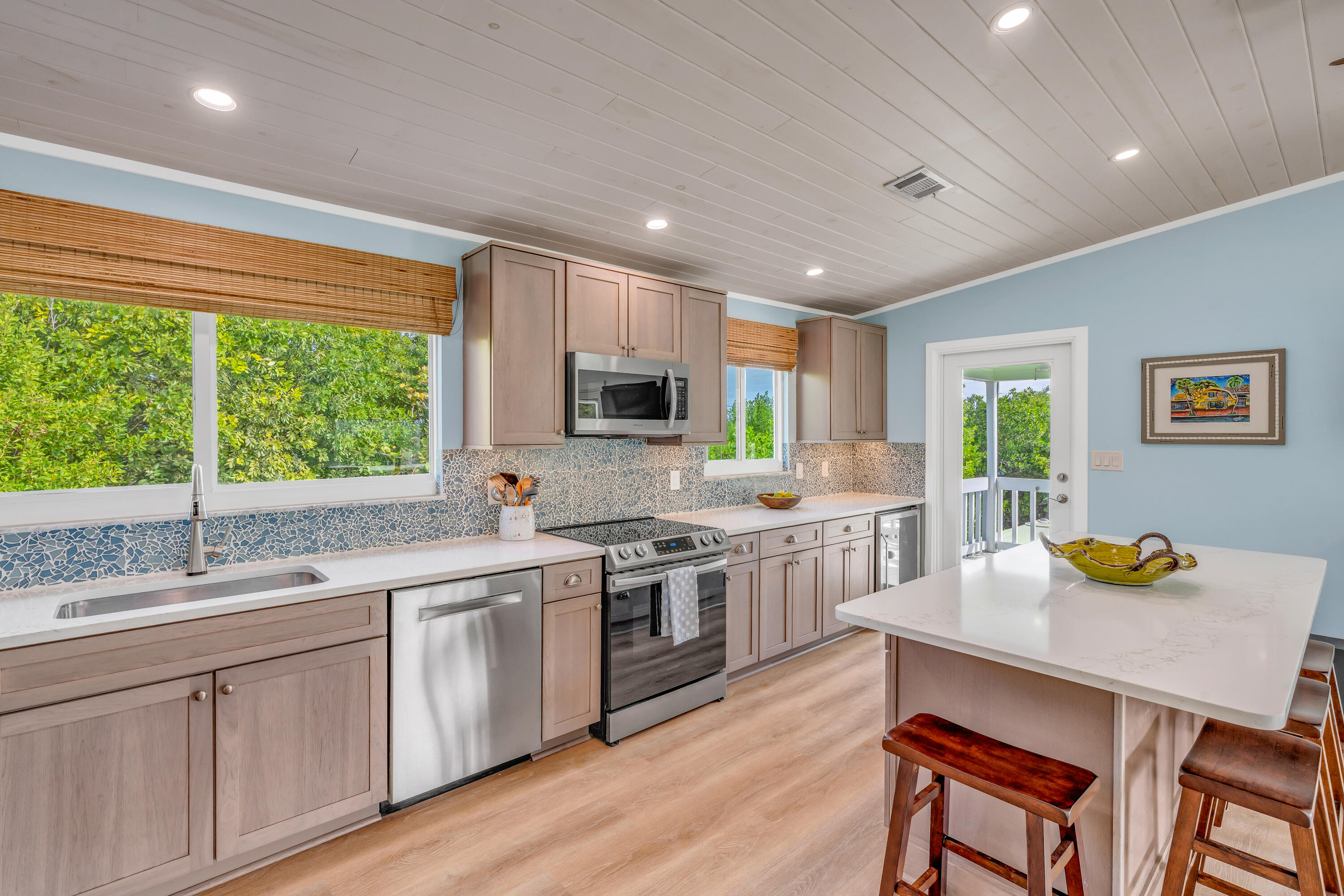 3987 Gordon Road Big Pine Key, FL 33043 - Photo 17 of 49 a kitchen with a sink a window and chairs