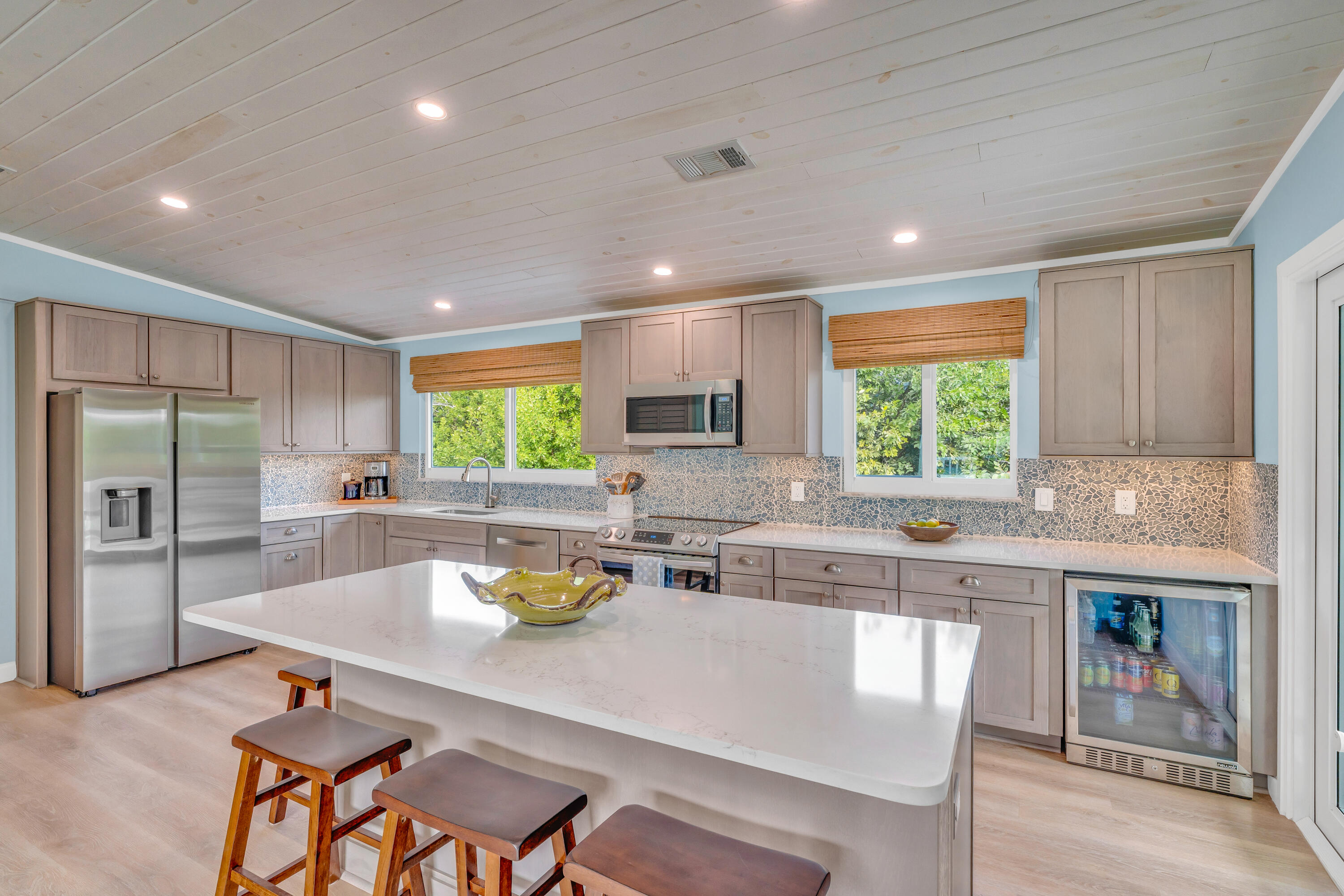 3987 Gordon Road Big Pine Key, FL 33043 - Photo 18 of 49 a kitchen with a table chairs microwave and cabinets