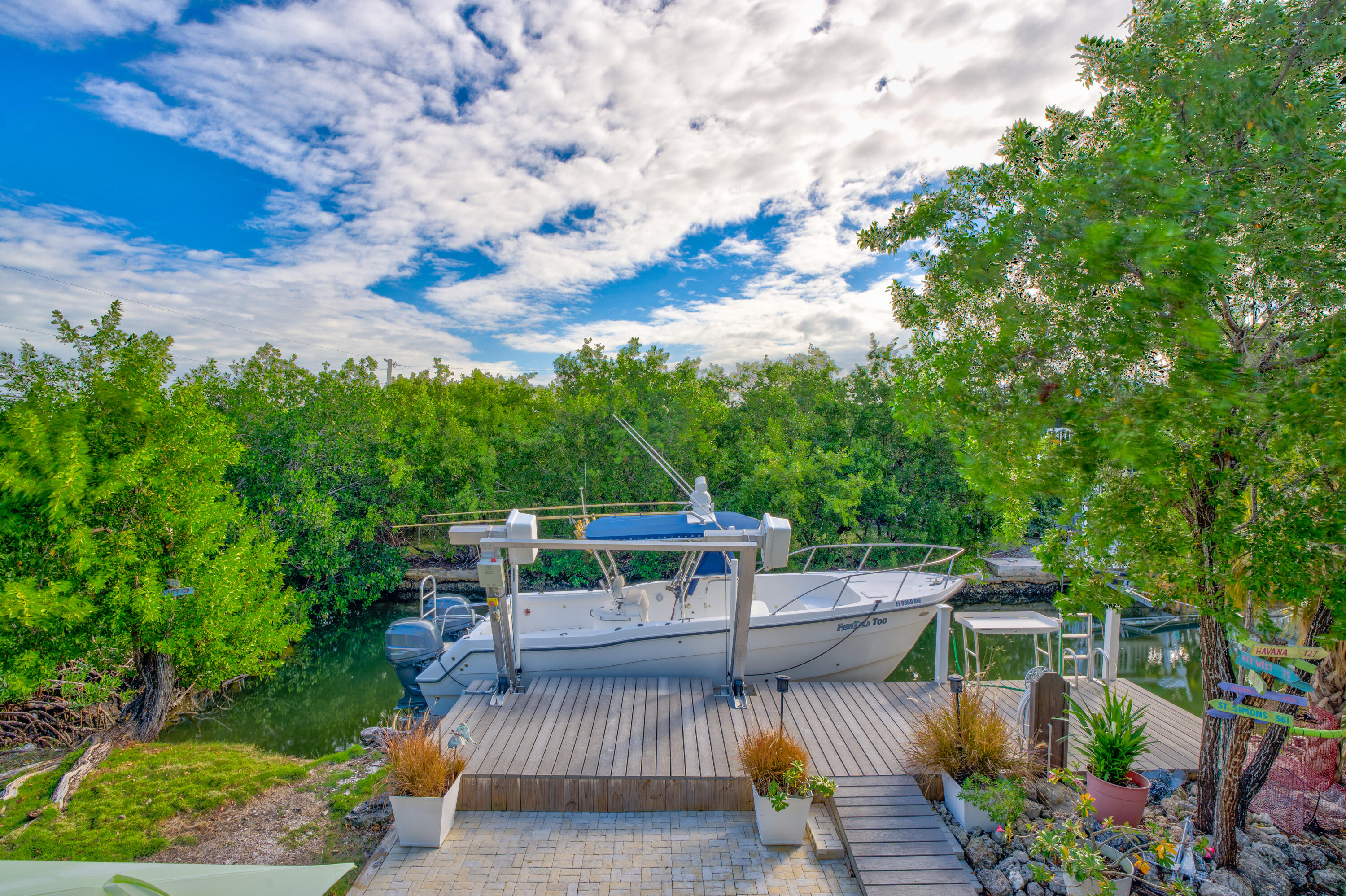 3987 Gordon Road Big Pine Key, FL 33043 - Photo 32 of 49 a balcony with wooden floor table and chairs