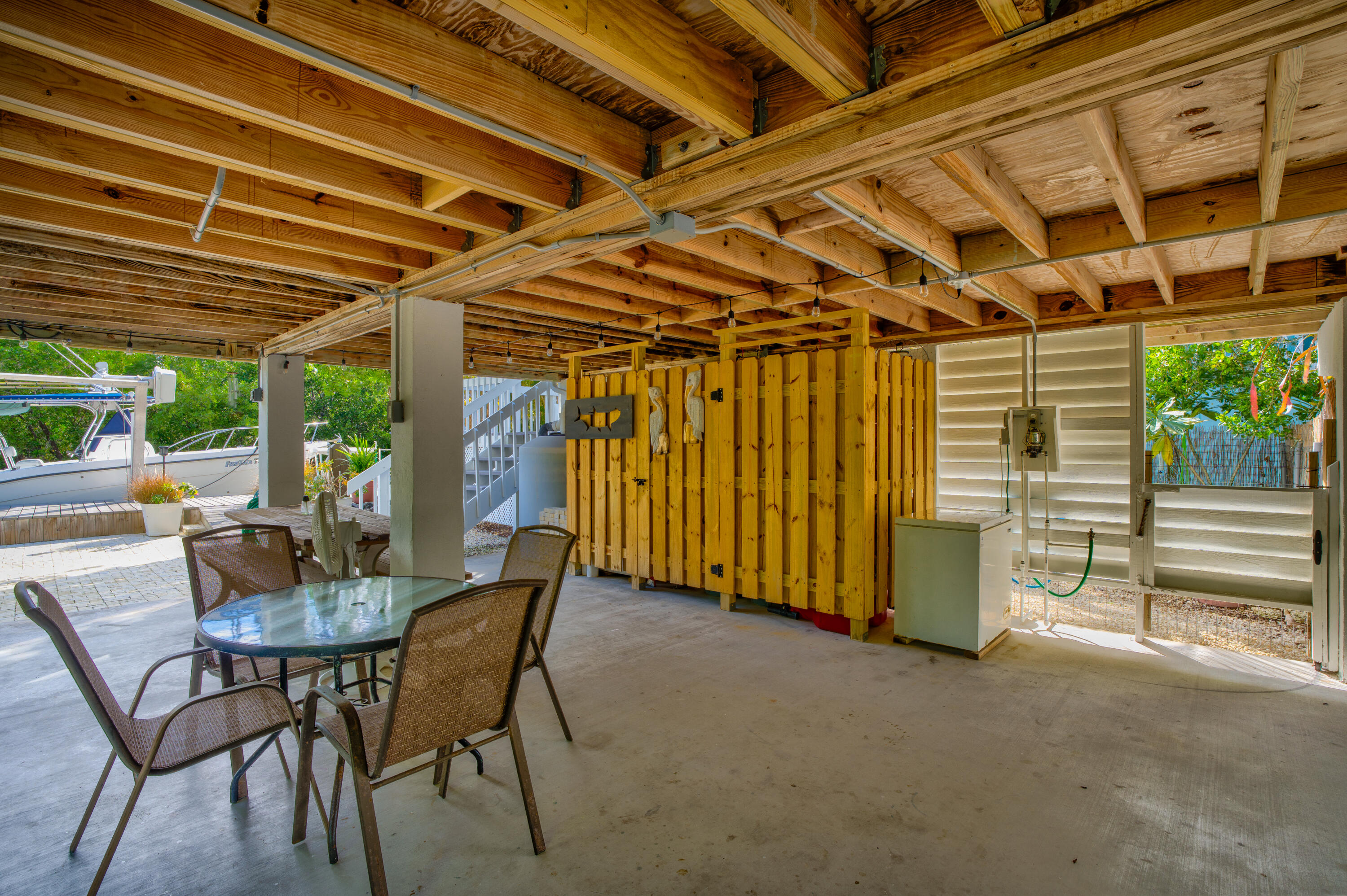 3987 Gordon Road Big Pine Key, FL 33043 - Photo 7 of 49 a view of a patio with table and chairs and potted plants