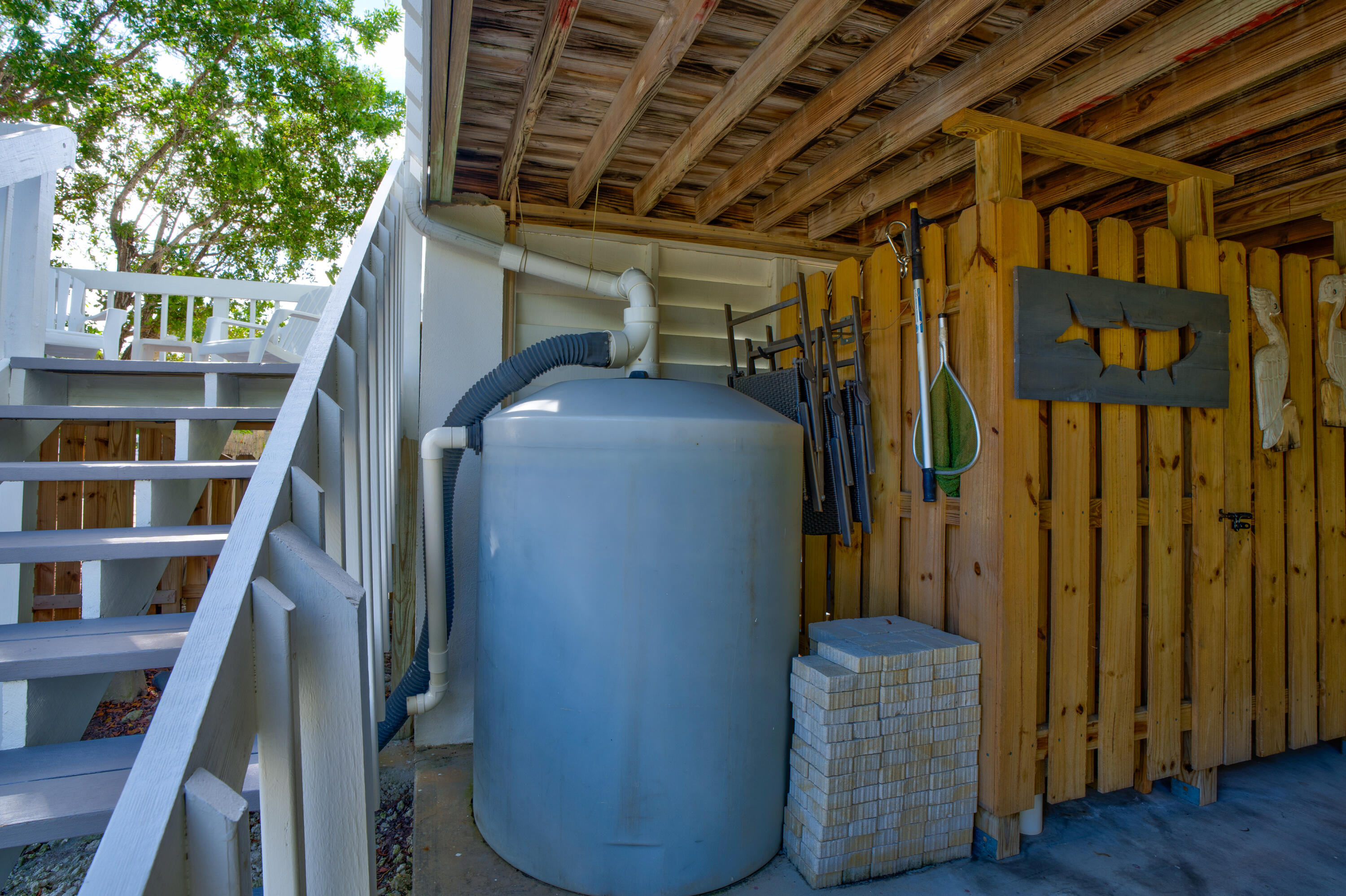 3987 Gordon Road Big Pine Key, FL 33043 - Photo 9 of 49 a view of an empty room with wooden floor and stairs