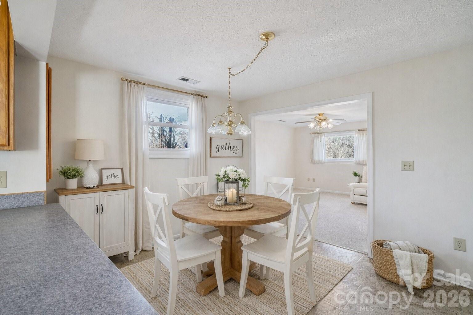 511 Oak Grove Road Flat Rock, NC 28731 - Photo 11 of 38 a view of a dining room with furniture and wooden floor