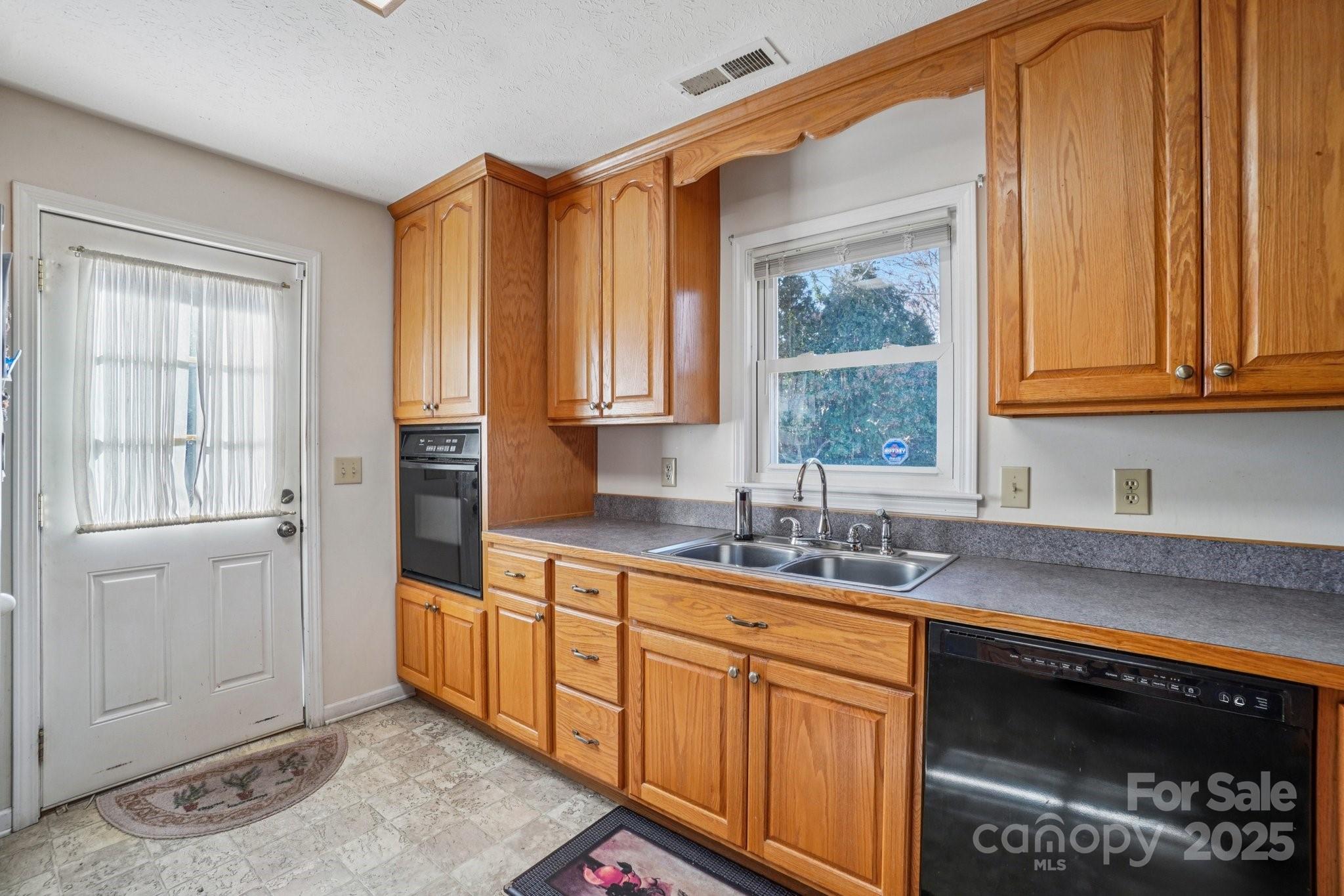 511 Oak Grove Road Flat Rock, NC 28731 - Photo 16 of 34 a kitchen with stainless steel appliances granite countertop a sink a stove and a microwave