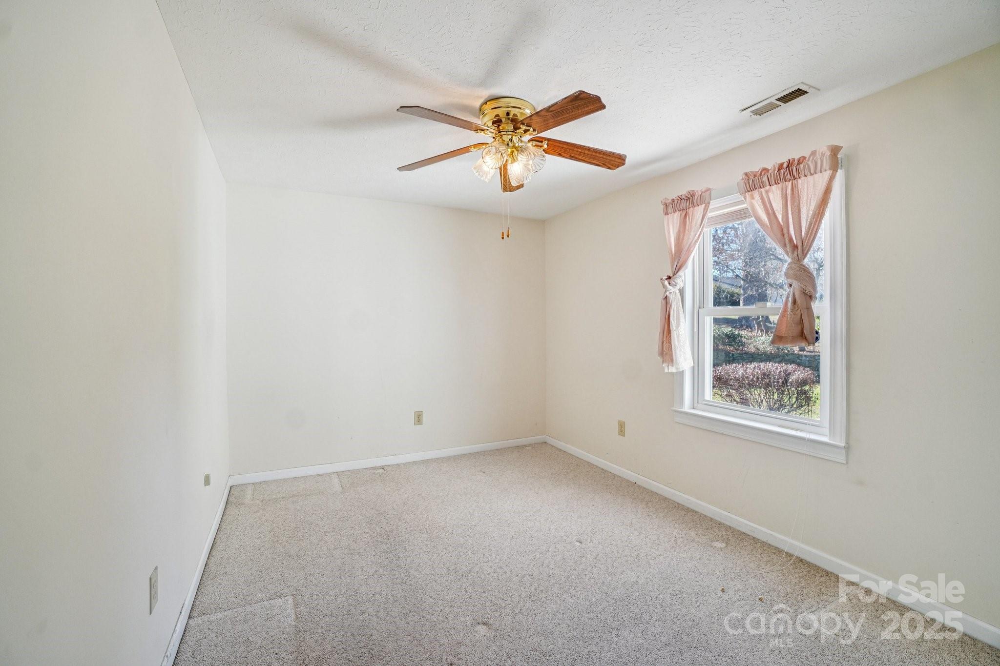 511 Oak Grove Road Flat Rock, NC 28731 - Photo 17 of 34 an empty room with windows and fan