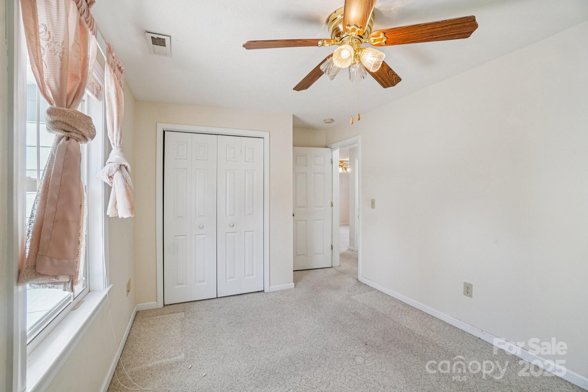 511 Oak Grove Road Flat Rock, NC 28731 - Photo 18 of 34 a view of empty room with ceiling fan