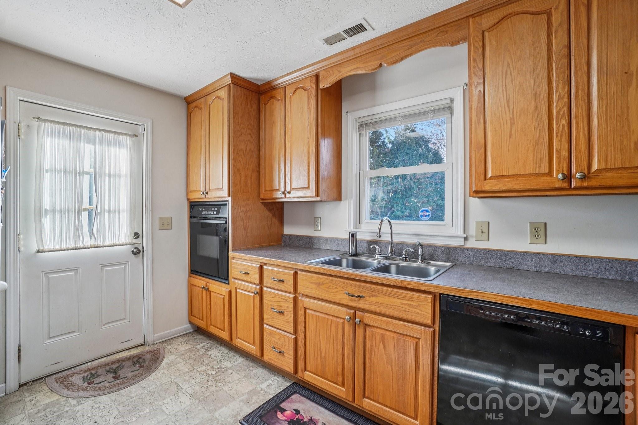 511 Oak Grove Road Flat Rock, NC 28731 - Photo 18 of 38 a kitchen with stainless steel appliances granite countertop a sink a stove and a microwave