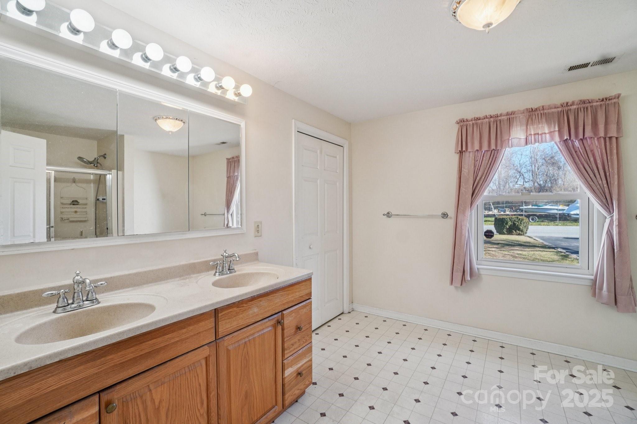 511 Oak Grove Road Flat Rock, NC 28731 - Photo 19 of 34 a bathroom with a sink a vanity and a mirror