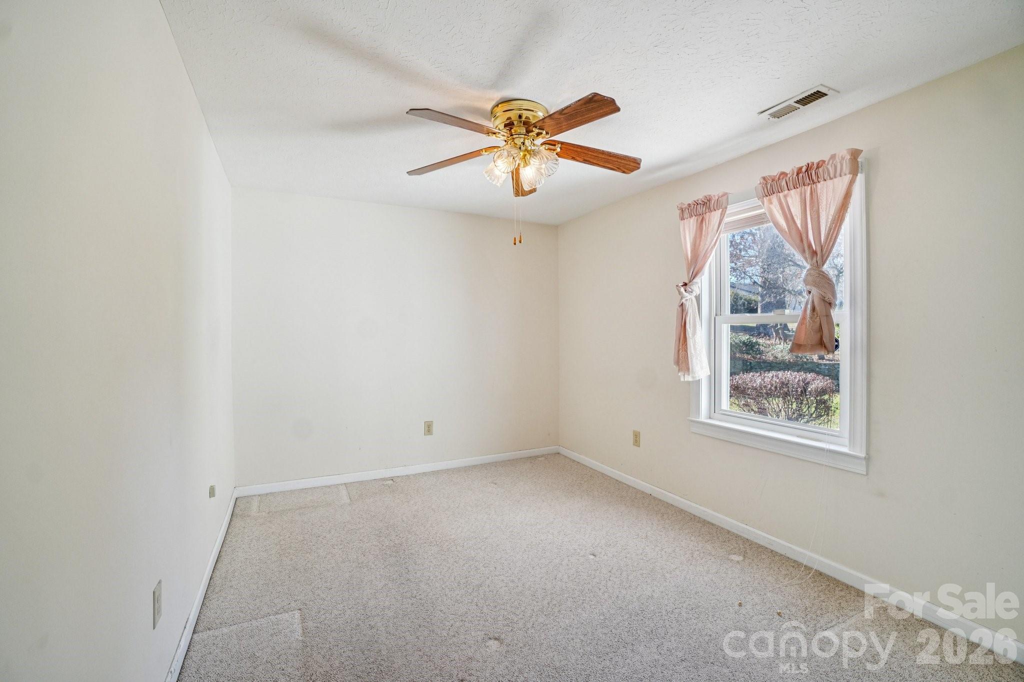 511 Oak Grove Road Flat Rock, NC 28731 - Photo 20 of 38 an empty room with windows and fan