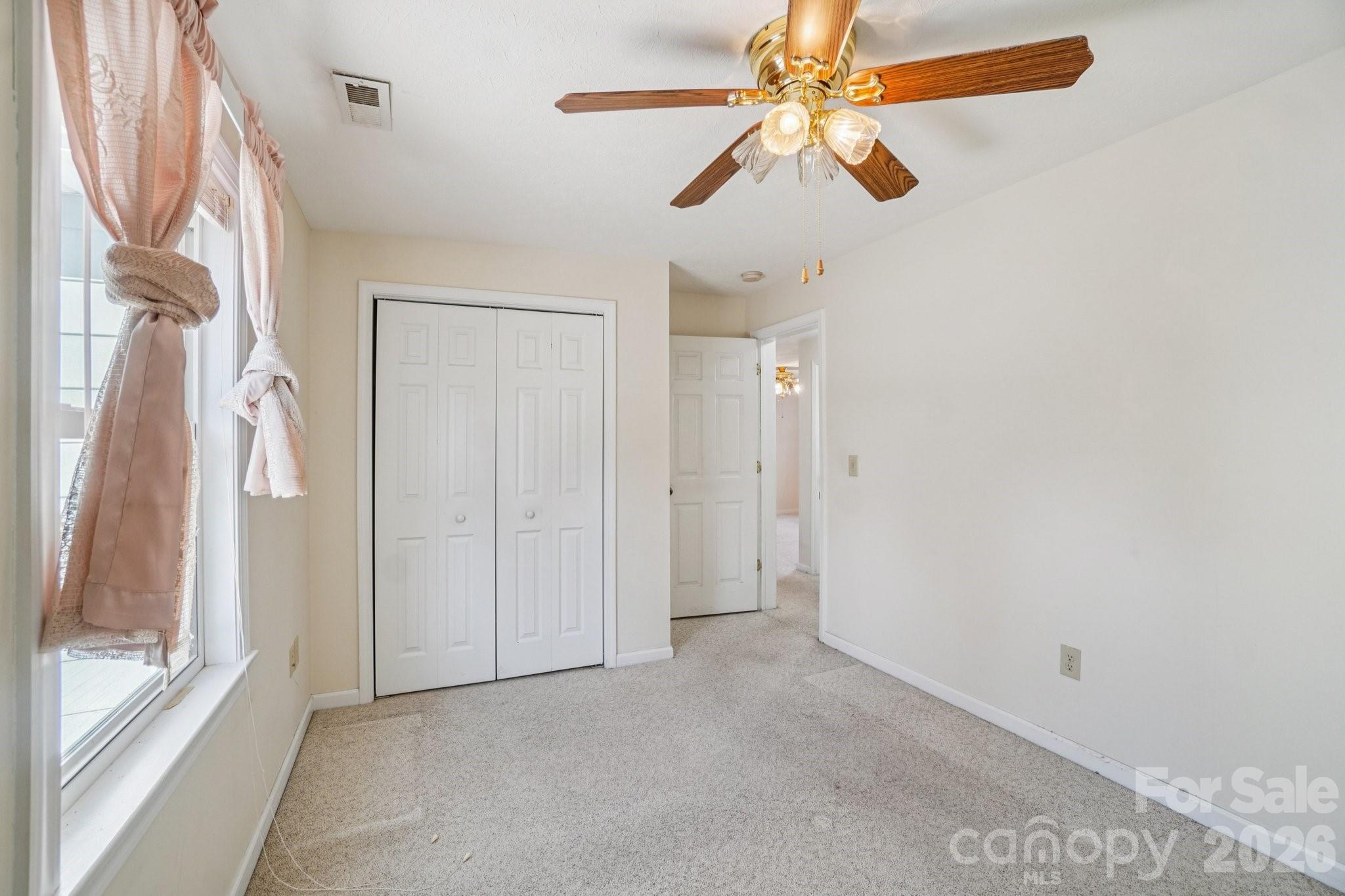 511 Oak Grove Road Flat Rock, NC 28731 - Photo 21 of 38 a view of empty room with ceiling fan