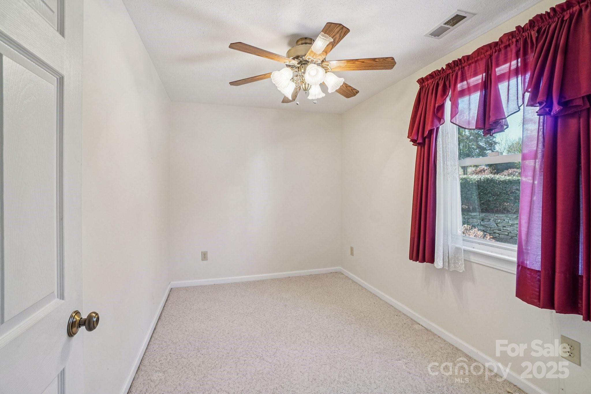 511 Oak Grove Road Flat Rock, NC 28731 - Photo 25 of 34 a view of an empty room with a window