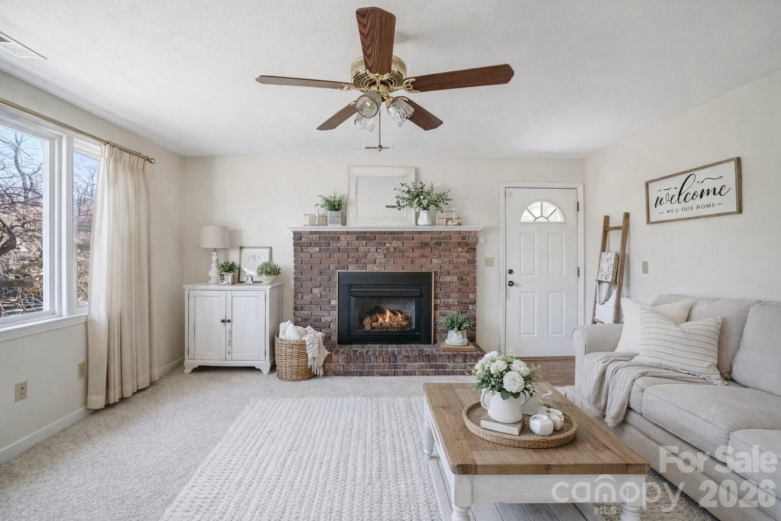 511 Oak Grove Road Flat Rock, NC 28731 - Photo 27 of 38 a living room with furniture a fireplace and a large window