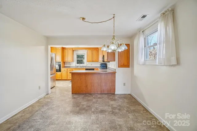 a view of a big room with windows and cabinet