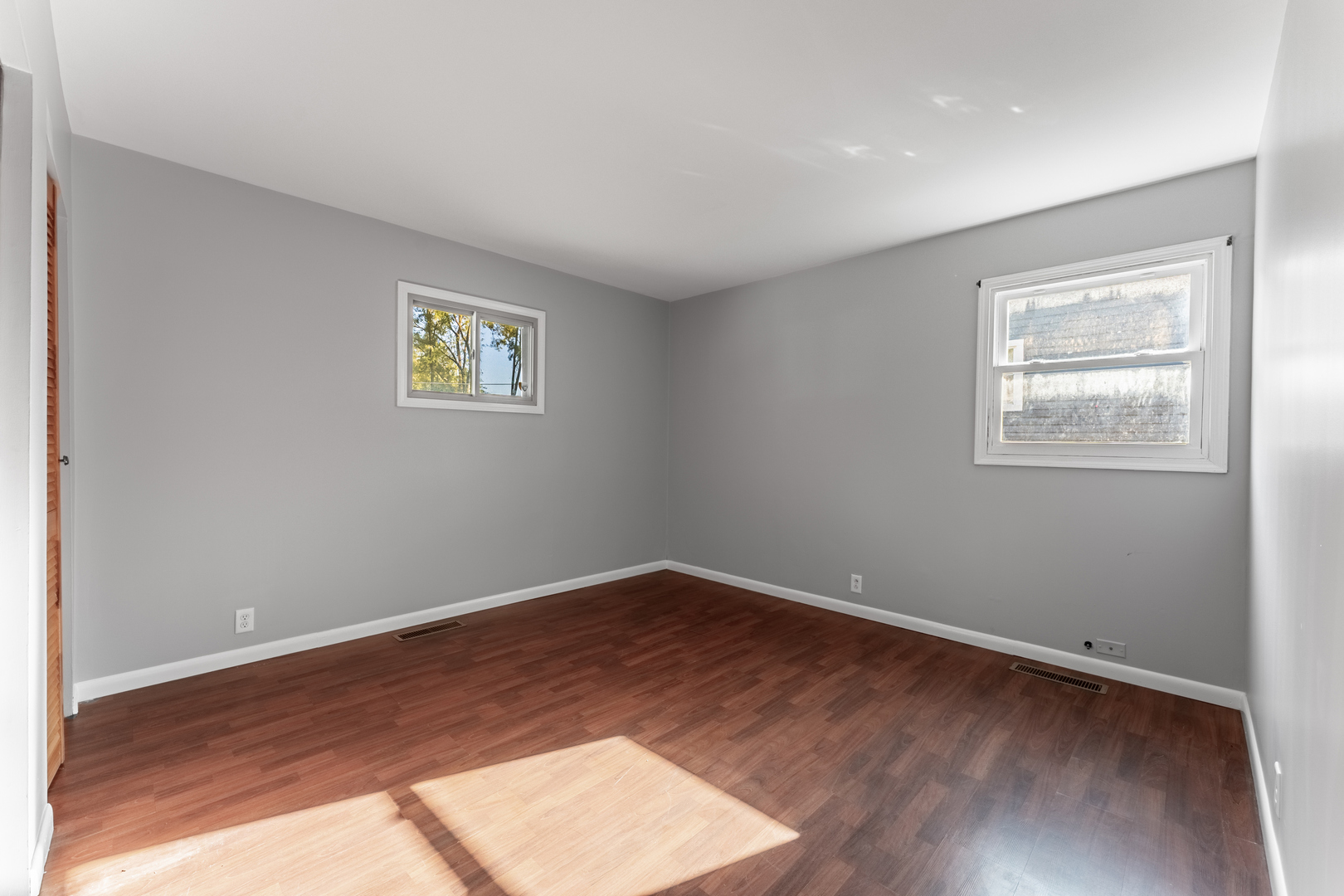 435 Douglas Road Batavia, IL 60510 - Photo 11 of 24 an empty room with wooden floor and windows