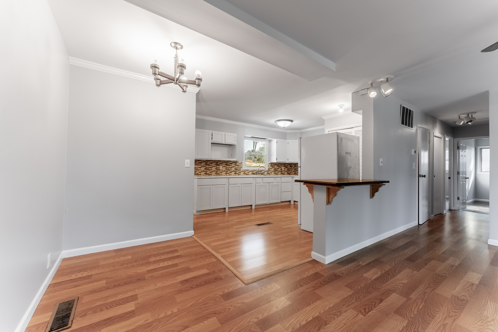 435 Douglas Road Batavia, IL 60510 - Photo 7 of 24 a view of kitchen and hall with wooden floor