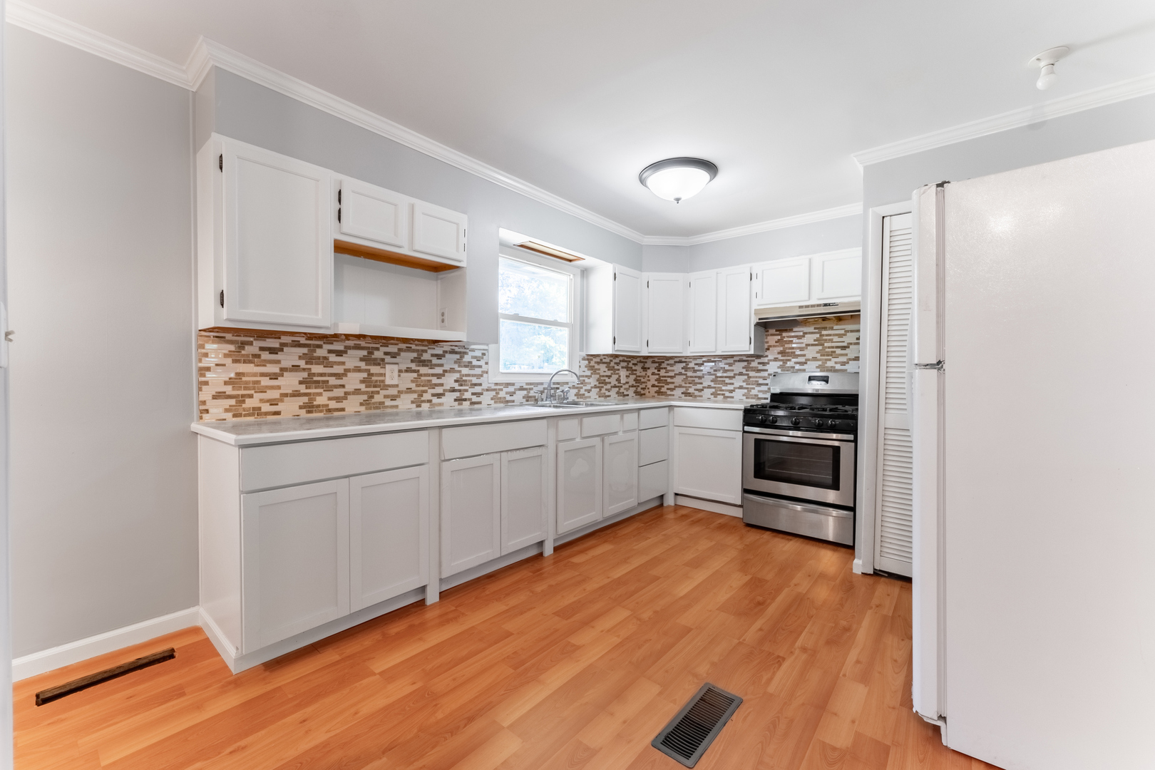 435 Douglas Road Batavia, IL 60510 - Photo 8 of 24 a kitchen with white cabinets and stainless steel appliances