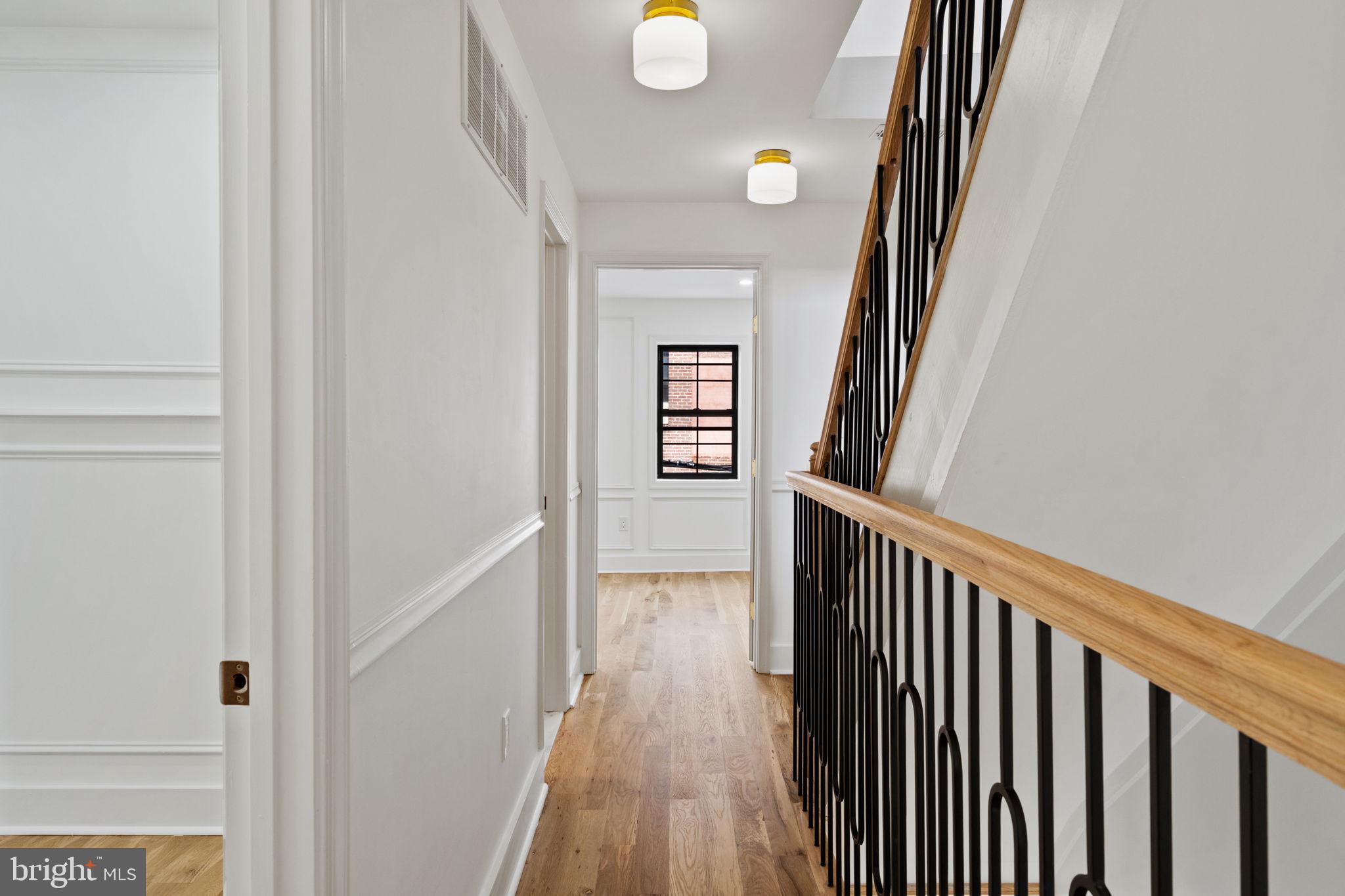 914 Fernon Street Philadelphia, PA 19148 - Photo 11 of 40 a view of a hallway with wooden floor and staircase
