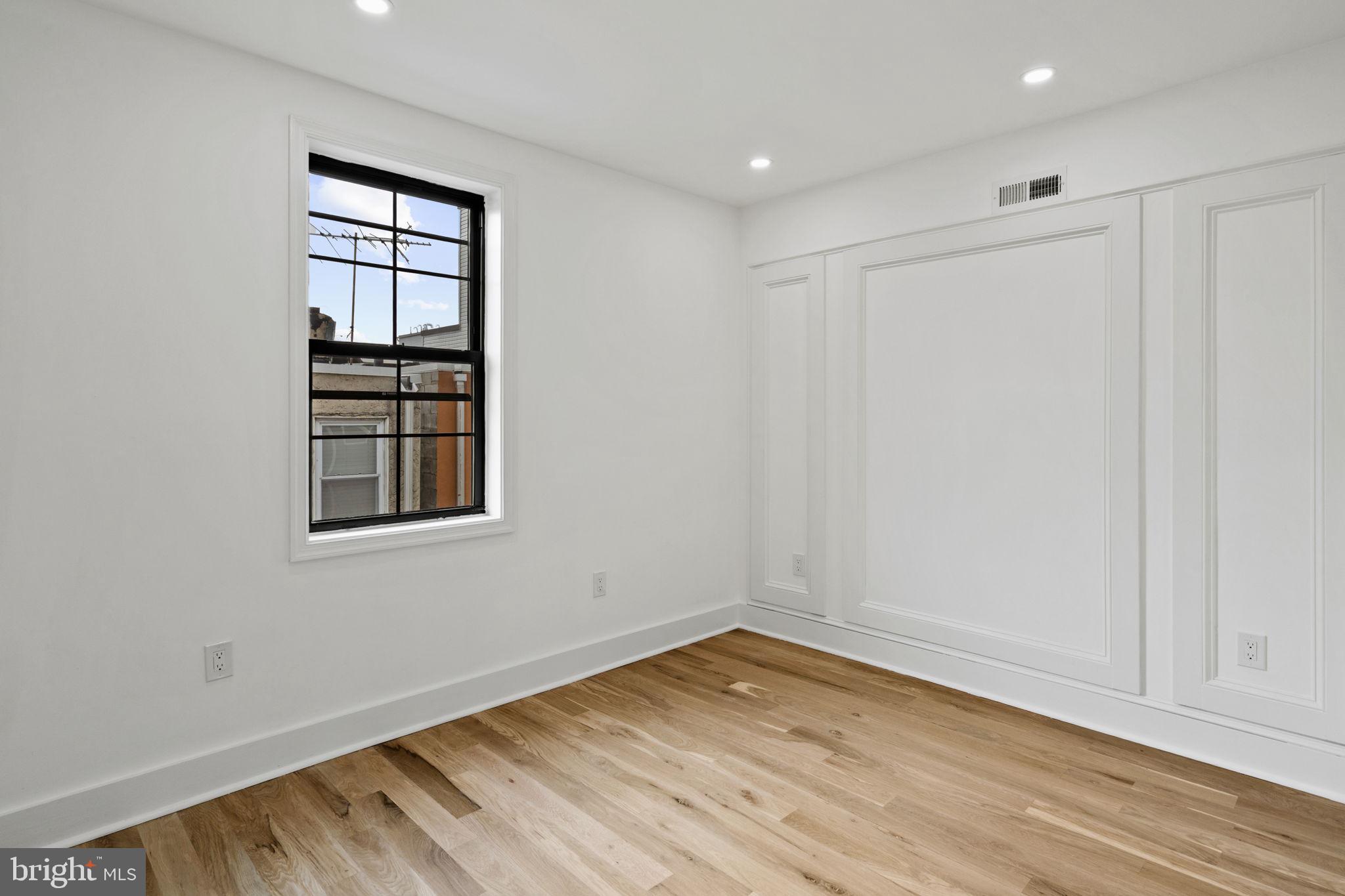 914 Fernon Street Philadelphia, PA 19148 - Photo 12 of 40 an empty room with wooden floor and windows